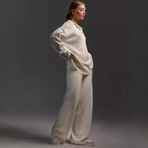 Woman wearing an oversized cream-colored fall winter two piece set with simple loose solid design